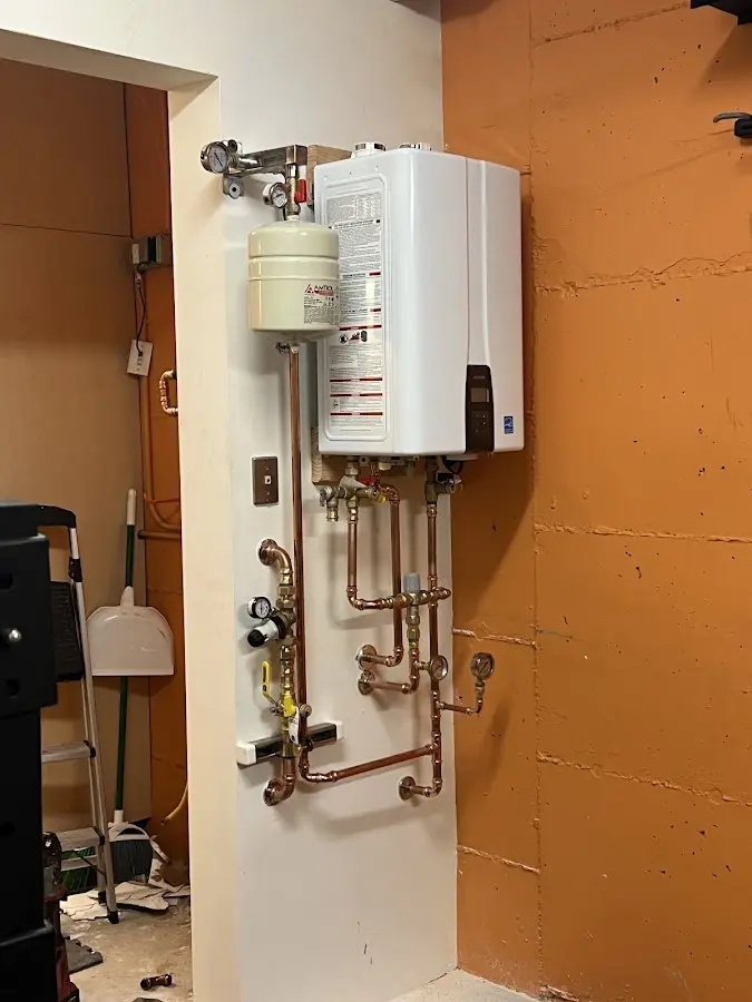 Plumbing technician inspecting water heater connections in Cheverly